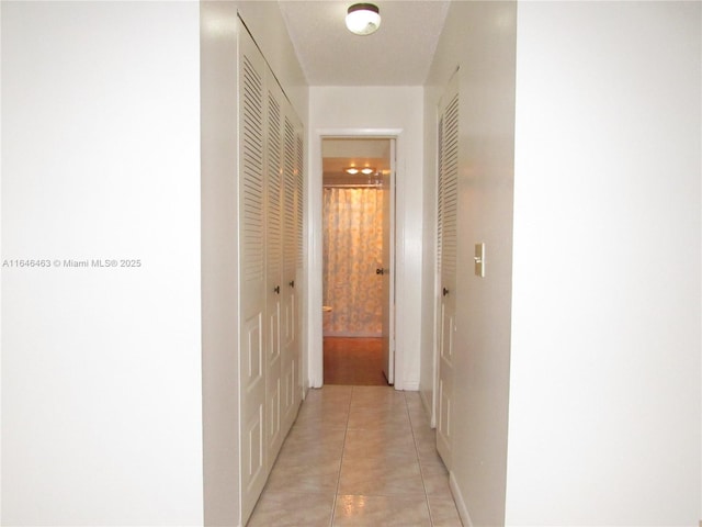 hallway featuring light tile patterned floors