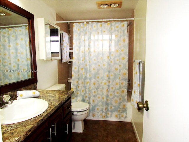 full bathroom with shower / tub combo with curtain, vanity, and toilet