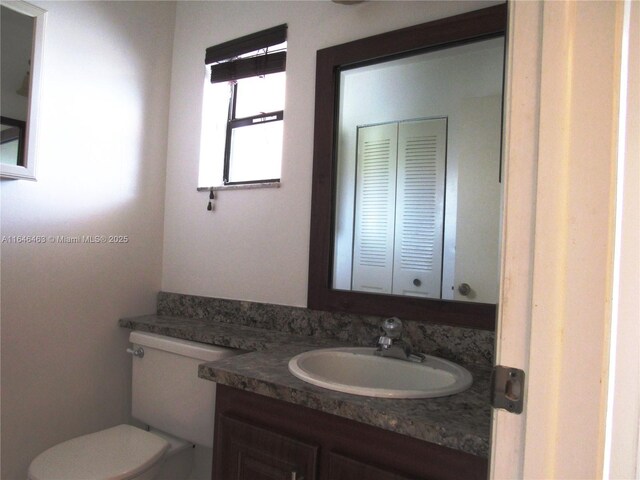 full bathroom with vanity, shower / bathtub combination with curtain, and toilet