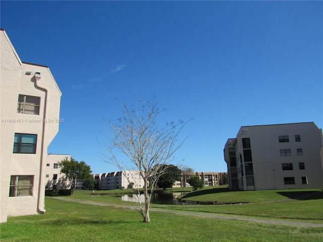 exterior space featuring a water view and a lawn