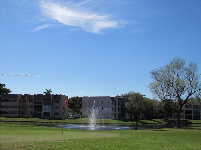 surrounding community featuring a water view and a yard