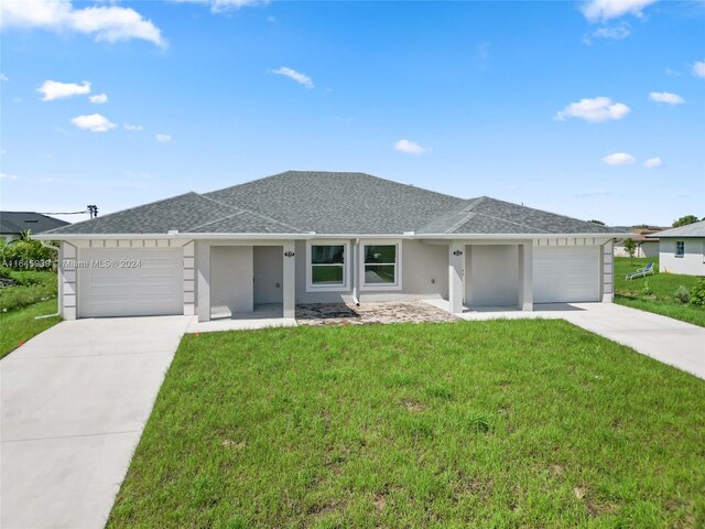 ranch-style house featuring a garage and a front yard