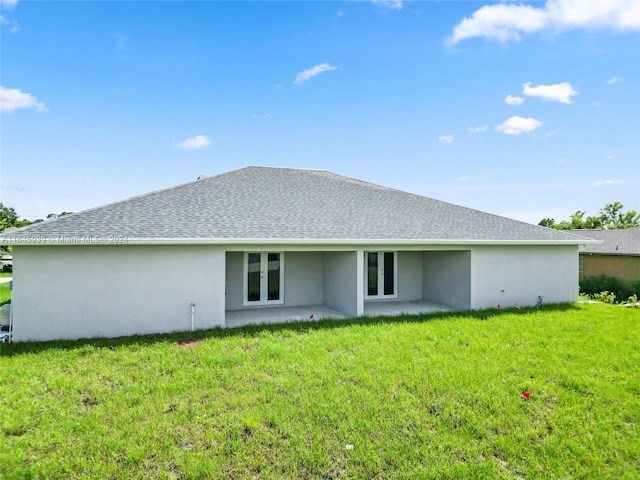 rear view of house with a patio area and a yard