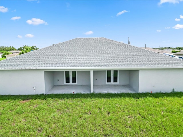 back of house with a patio area and a lawn