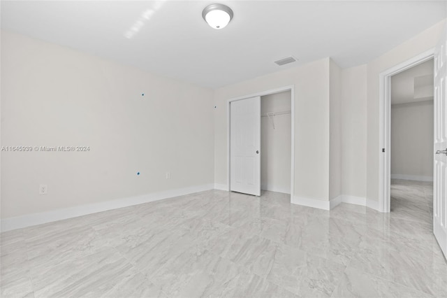 unfurnished bedroom featuring a closet and light tile patterned flooring