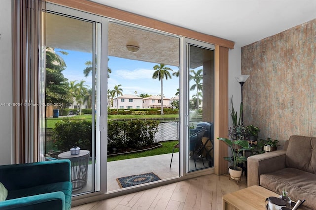 entryway with hardwood / wood-style floors and a water view