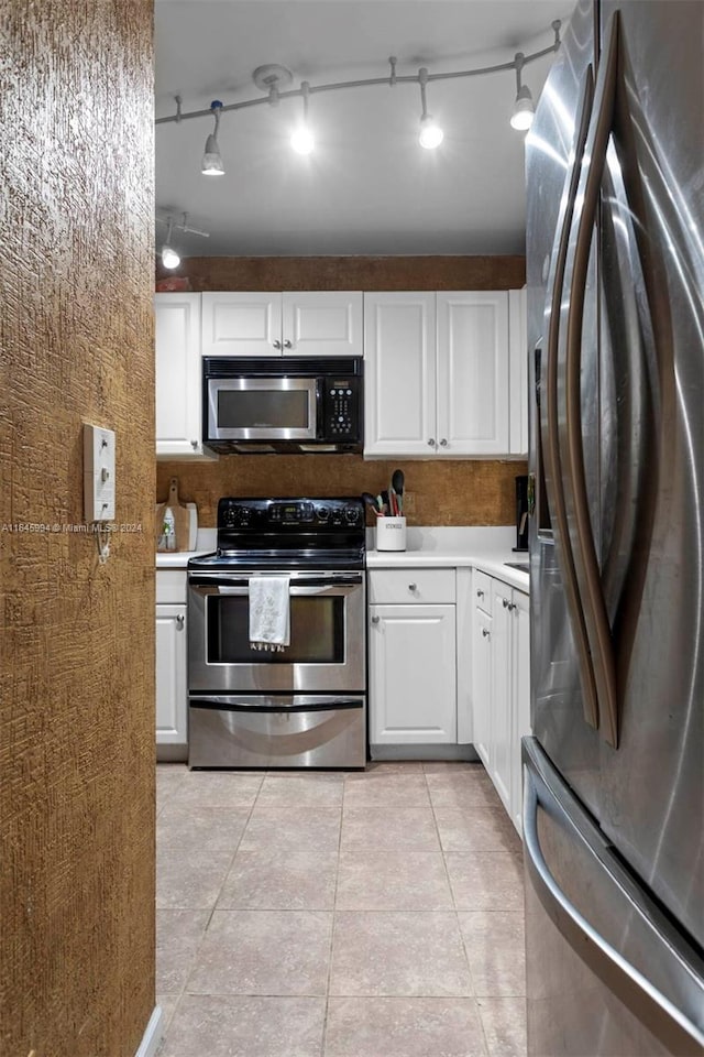 kitchen featuring stainless steel appliances, white cabinetry, and track lighting