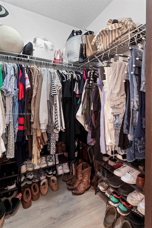 spacious closet featuring hardwood / wood-style floors