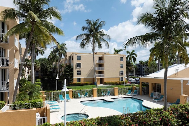 view of swimming pool with a patio and a hot tub