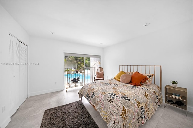 bedroom with a closet, access to outside, and light tile patterned floors