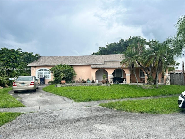 single story home with a front lawn