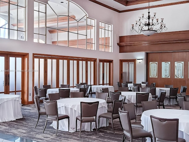 dining area with a healthy amount of sunlight and a towering ceiling