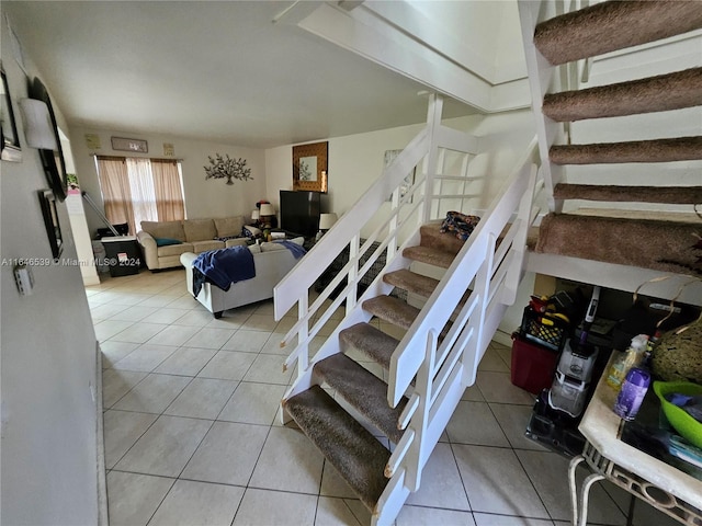 staircase featuring tile patterned flooring