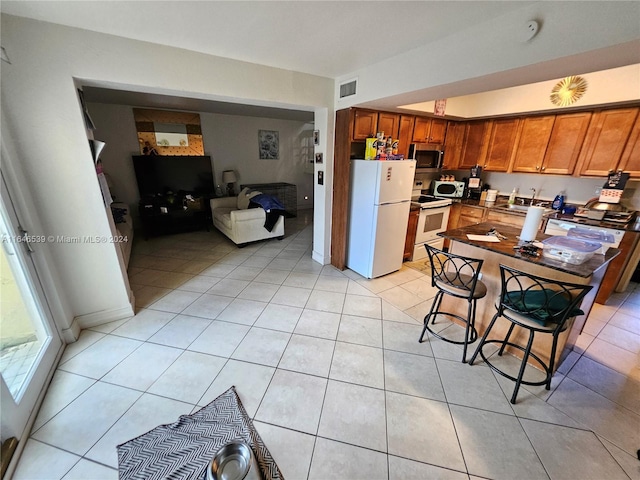 kitchen featuring white appliances and light tile patterned floors