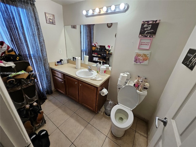 bathroom featuring tile patterned flooring, vanity, and toilet