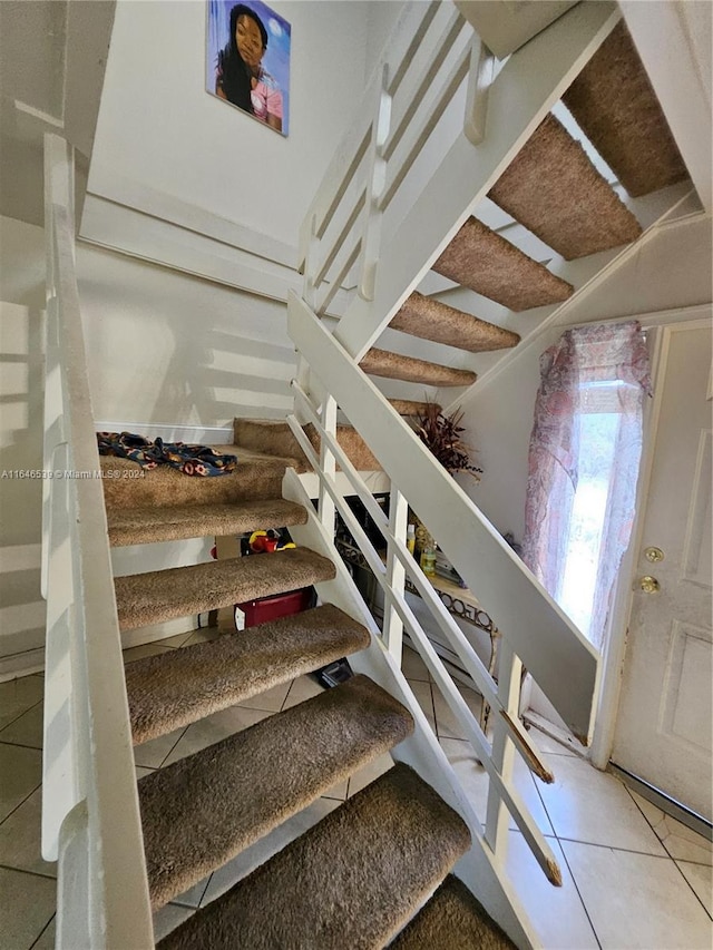 stairs featuring tile patterned floors