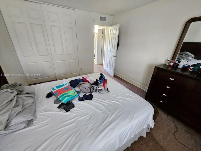 carpeted bedroom with a closet