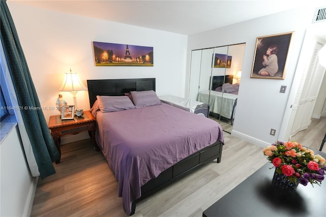 bedroom with light wood-type flooring and a closet