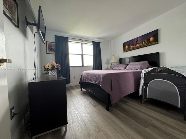 bedroom with hardwood / wood-style floors