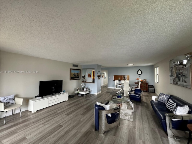 living room featuring hardwood / wood-style flooring and a textured ceiling