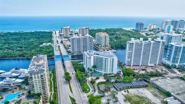 birds eye view of property featuring a water view and a city view