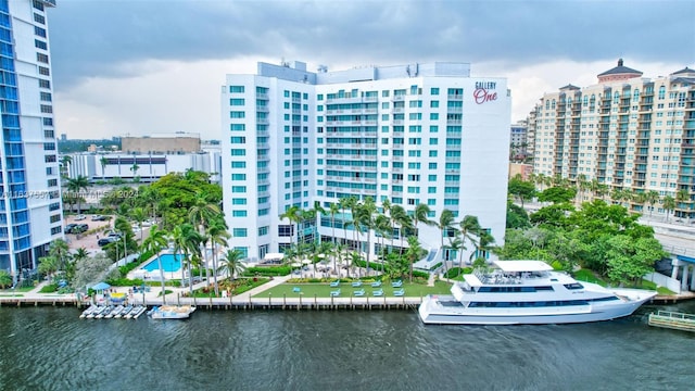 view of building exterior featuring a water view and a city view