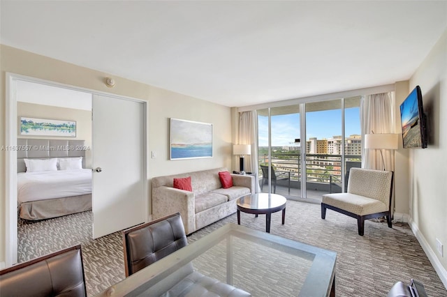 carpeted living room featuring a wall of windows and baseboards