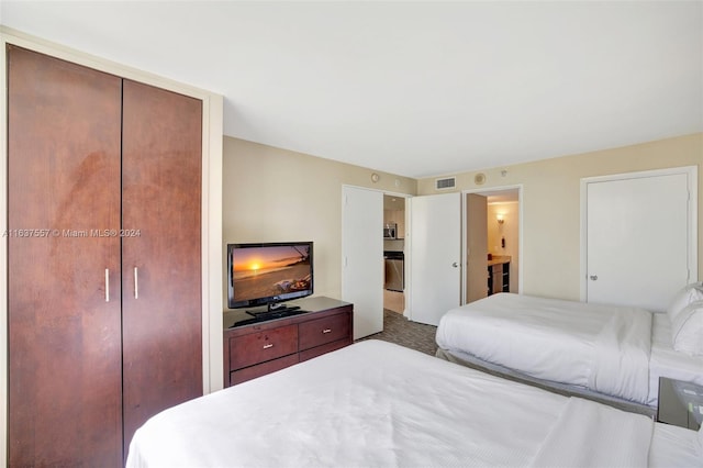 bedroom with carpet, visible vents, and connected bathroom