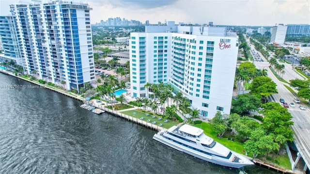 birds eye view of property with a water view and a city view