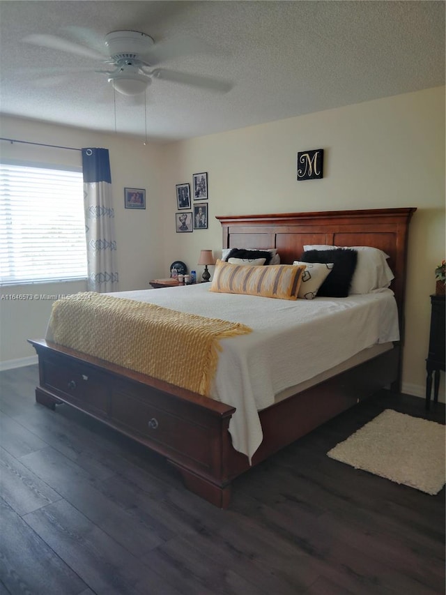 bedroom featuring dark hardwood / wood-style flooring, a textured ceiling, and ceiling fan