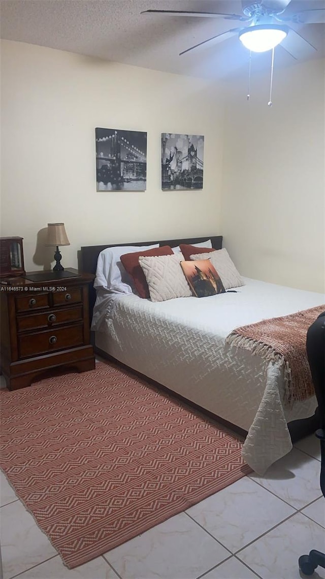 bedroom with a textured ceiling and ceiling fan