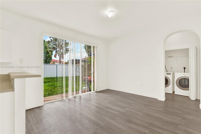 unfurnished room featuring washer and dryer and wood finished floors