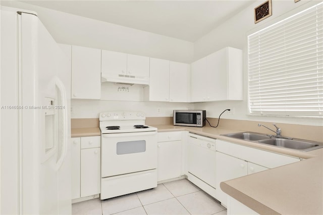 kitchen with white appliances, light countertops, under cabinet range hood, and a sink