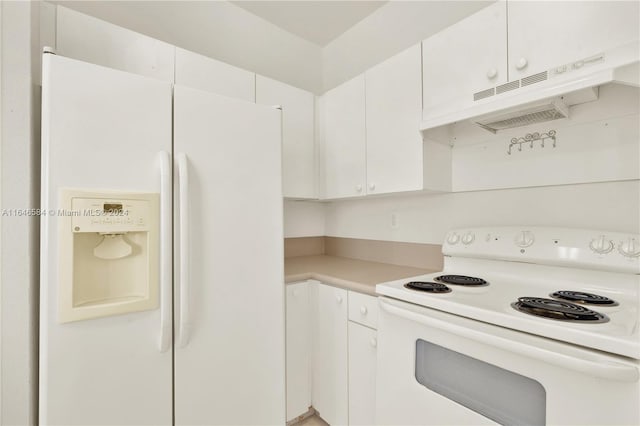 kitchen with white appliances, white cabinets, and light countertops