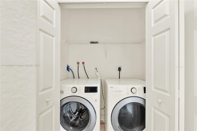 washroom with laundry area and washing machine and clothes dryer