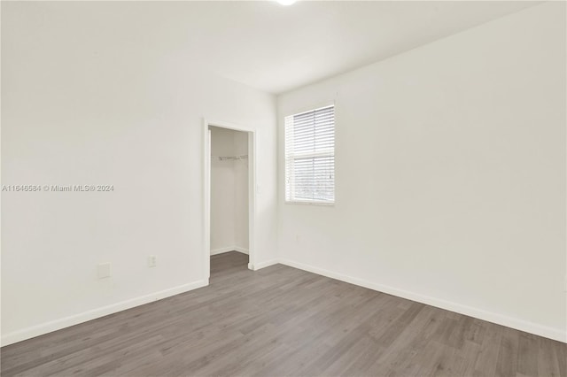 empty room with wood finished floors and baseboards