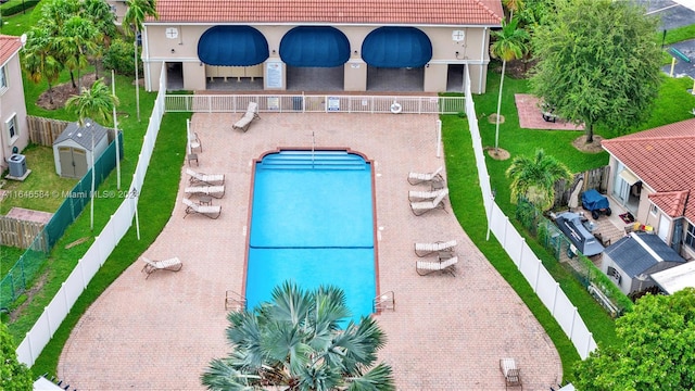 pool featuring a fenced backyard, a lawn, and a patio