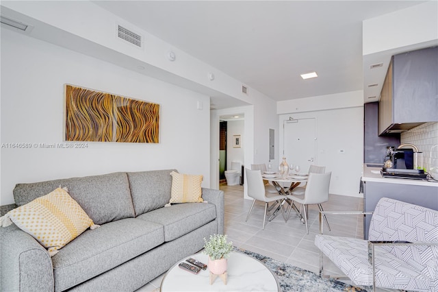 tiled living room featuring electric panel