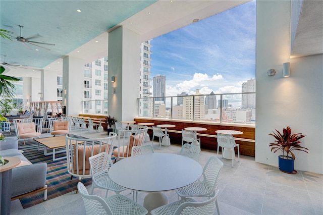 view of patio / terrace with a balcony and ceiling fan