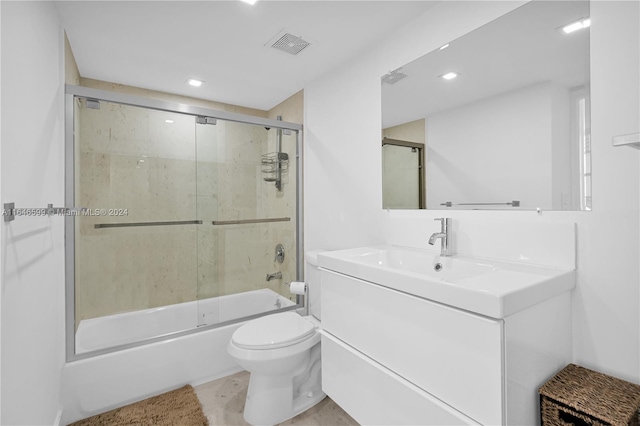 full bathroom with vanity, combined bath / shower with glass door, and toilet