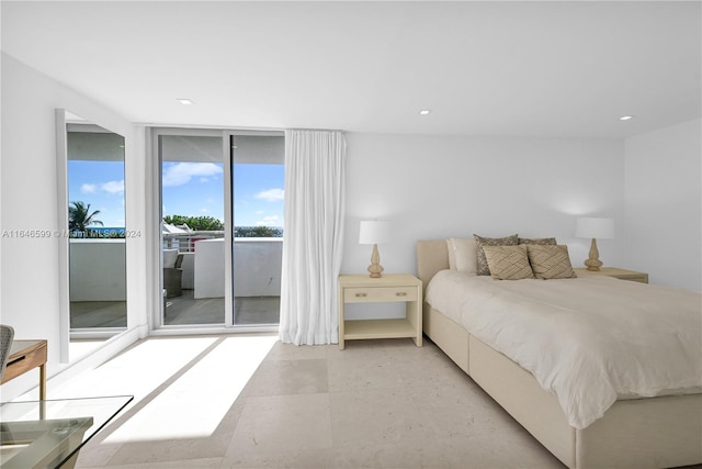 bedroom with a wall of windows and access to outside