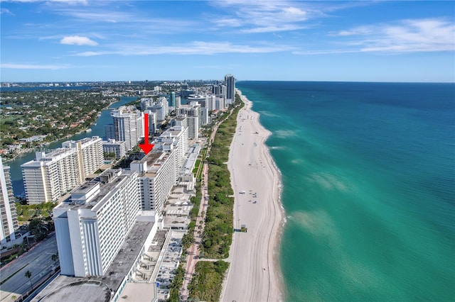 aerial view with a water view and a beach view