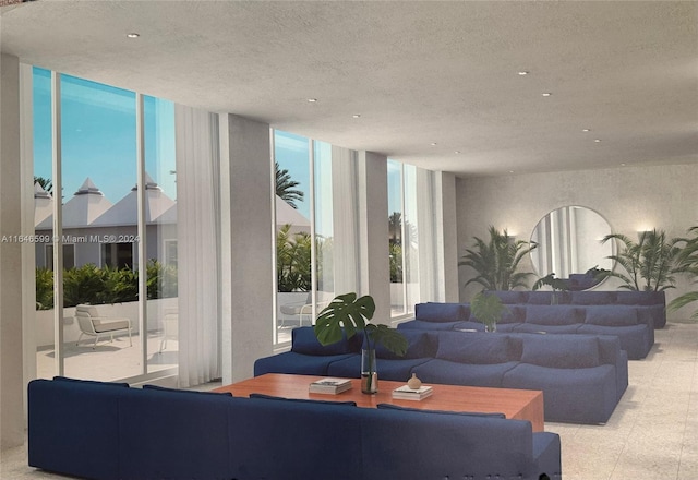 living room featuring a textured ceiling and floor to ceiling windows