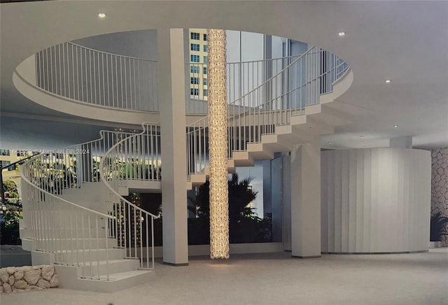 staircase with a towering ceiling