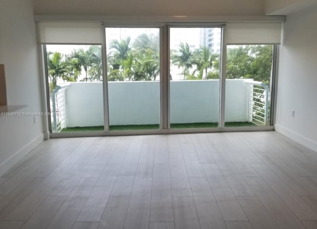 unfurnished room with wood-type flooring