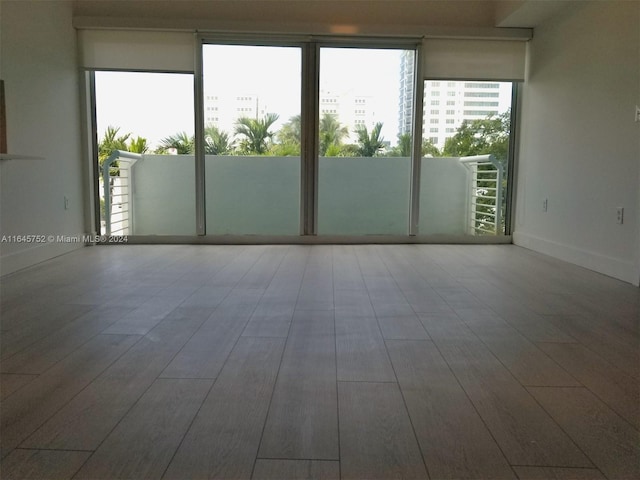 unfurnished room featuring hardwood / wood-style flooring