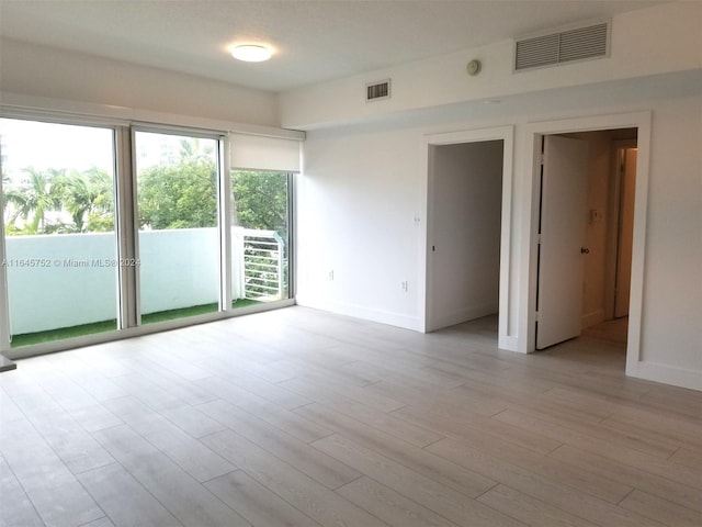 spare room featuring light hardwood / wood-style flooring