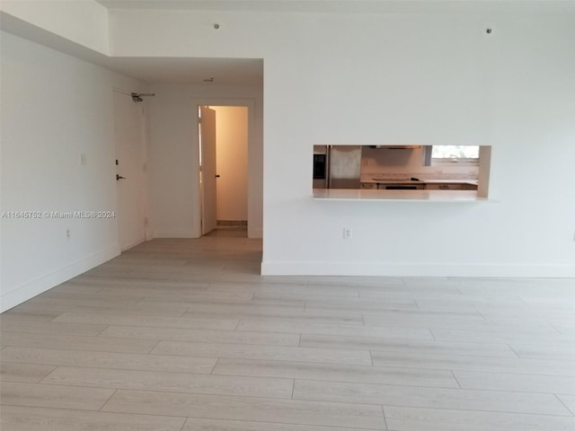 unfurnished room with light wood-type flooring