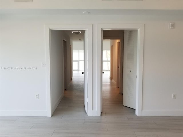 corridor with wood-type flooring