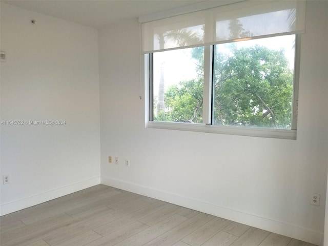 unfurnished room featuring hardwood / wood-style flooring